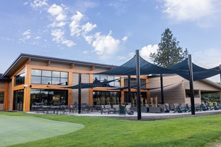 Warm Springs Grill and Golf Exterior with tables and shades.